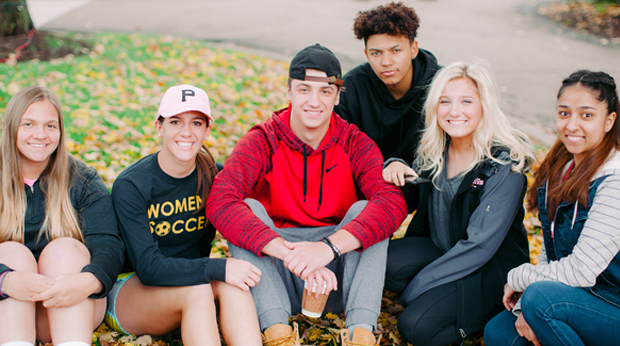 La Roche University Students sitting on the lawn on campus