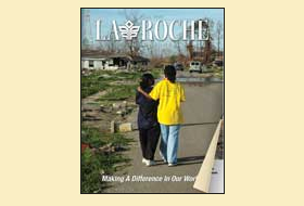 The cover of the Fall 2006 issue of the La Roche magazine. The cover photo shows two people with their arms over each other walking down a road outside. 