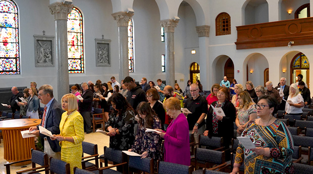 La Roche University students stand for a Baccalaureate Mass in the Motherhouse Chapel.